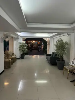 a large living room with couches and plants in it at Boomerang Inn in Patong Beach