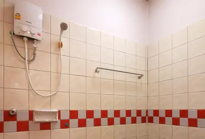 a bathroom with a shower with red and white tiles at Baan Nat The Village in Phuket Town