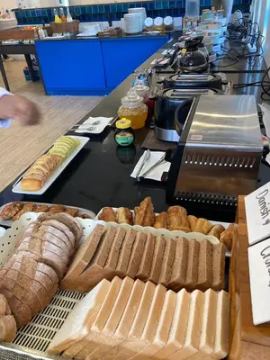 a table topped with lots of different types of bread at The Viridian Resort Patong in Patong Beach