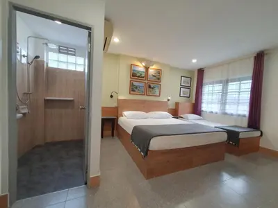 a bedroom with a bed and a walk in shower at Holiday Village And Natural Garden Resort in Karon Beach