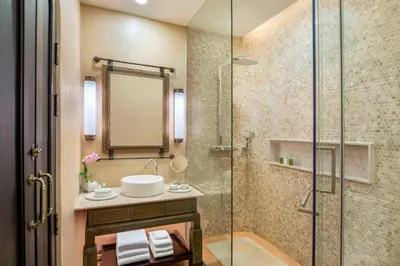 a bathroom with a glass shower and a sink at The Naka Island, a Luxury Collection Resort & Spa, Phuket in Ko Naka