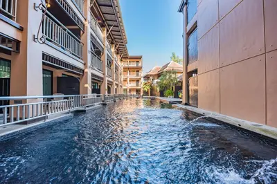 a water canal between two buildings in a city at Princess Kamala Beachfront Hotel - SHA Extra Plus in Kamala Beach