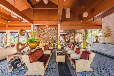 a lobby with a long line of couches at Princess Kamala Beachfront Hotel - SHA Extra Plus in Kamala Beach