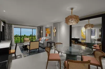 a living room with a glass table and chairs at Marriott's Mai Khao Resort - Phuket in Mai Khao Beach