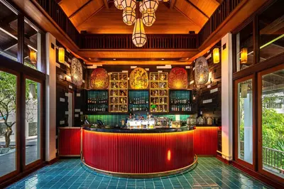 a bar in a restaurant with a red counter at Marriott's Mai Khao Resort - Phuket in Mai Khao Beach