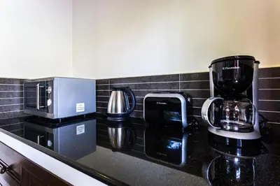 a kitchen counter with a coffeemaker and a coffee maker at Phuket Pool Residence - Adults only in Rawai Beach