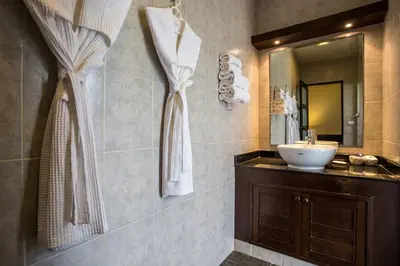 a bathroom with a sink and a mirror at Phuket Pool Residence - Adults only in Rawai Beach