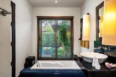 a bathroom with a large tub and a sink at Emerald Pool Villa Lush Villa On A Sunny Island in Nai Harn Beach