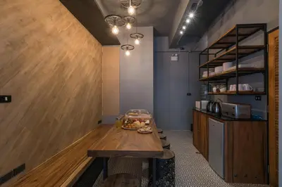 a kitchen with a table with a bowl of food on it at Sleep Box Patong Hostel in Patong Beach