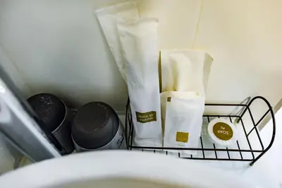 a shelf in a bathroom with toiletries and a basket at Thai Kamala Beach Front in Kamala Beach