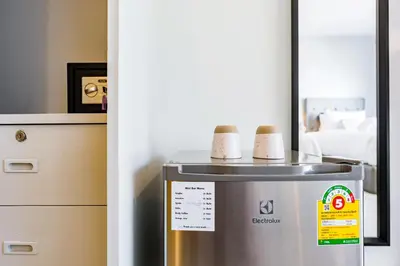 a refrigerator with two cups on top of it at Thai Kamala Beach Front in Kamala Beach