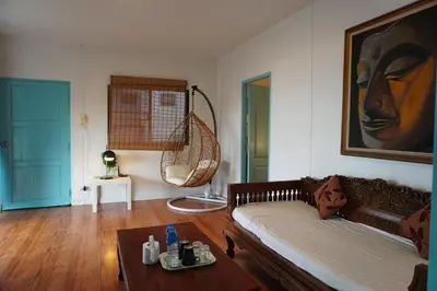 a living room with a couch and a table at Residy Retreat x Baan Suan Villa in Patong Beach