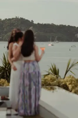 two women standing on a ledge looking at the water at Amatara Welleisure Resort in Panwa Beach