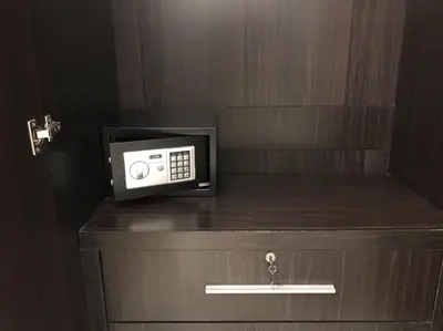 a microwave sitting on top of a wooden cabinet at Buncha Place in Bang Tao Beach