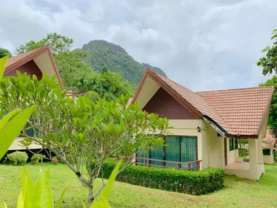 a house with a tree in front of it at Kannapat House in Ban Nong Thale