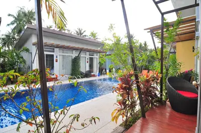 a house with a swimming pool in front of a house at Phu NaNa Boutique Hotel - SHA Plus in Rawai Beach
