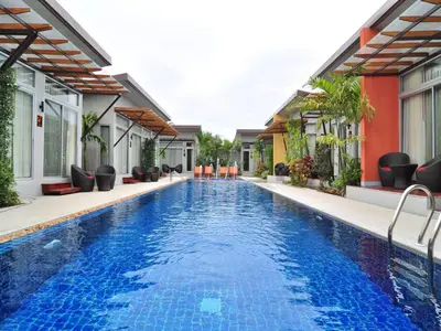 a swimming pool in the middle of a house at Phu NaNa Boutique Hotel - SHA Plus in Rawai Beach