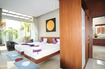 a bedroom with a large bed and a large window at Phu NaNa Boutique Hotel - SHA Plus in Rawai Beach