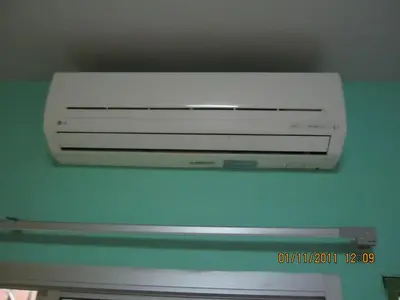 a white air conditioner hanging from a ceiling at Popeye Guesthouse in Ao Nang Beach
