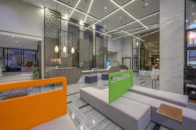 a lobby of a building with orange and green at Zenseana Resort & Spa - Patong, Phuket in Patong Beach