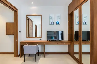 a room with a desk with a tv and a mirror at Villa Palavee (B1) in Ao Nang Beach