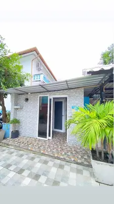 a white brick house with a palm tree at The Villa Residences Resort in Patong Beach