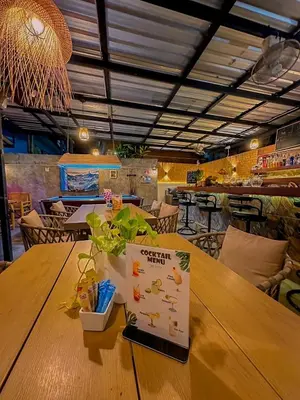 a table in a restaurant with a sign on it at The Villa Residences Resort in Patong Beach