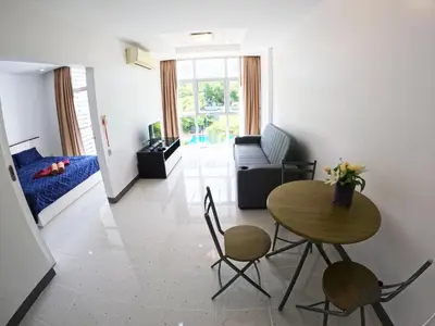 a living room with a table and chairs and a couch at At Seacondo-Excellent-B26 in Klong Muang Beach