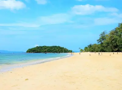 a beach with a group of people in the water at At Seacondo-1 Bedroom-A12 in Klong Muang Beach