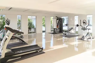 a gym with several treadmills and cardio machines at At Seacondo-1 Bedroom-A12 in Klong Muang Beach