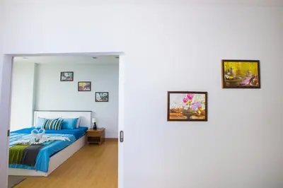 a bedroom with a bed and pictures on the wall at At Seacondo-1 Bedroom-A20 in Klong Muang Beach