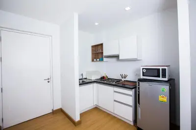 a small kitchen with a refrigerator and a microwave at At Seacondo-1 Bedroom-A25 in Klong Muang Beach