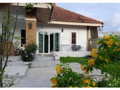 a small white house with flowers in front of it at 3BR Villa near Laguna beach in Bang Tao Beach