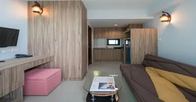 a living room with a couch and a table at Peace Blue Naiharn Naturist Resort Phuket SHA Extra Plus in Rawai Beach