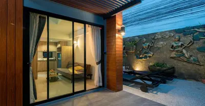 a room with a wall with a painting on it at Peace Blue Naiharn Naturist Resort Phuket SHA Extra Plus in Rawai Beach