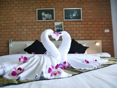two swans making a heart shape on a bed at Bests Village & Villa - Chalong Bay Phuket in Chalong