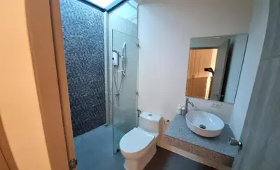 a bathroom with a toilet and a shower and a sink at Bests Village & Villa - Chalong Bay Phuket in Chalong