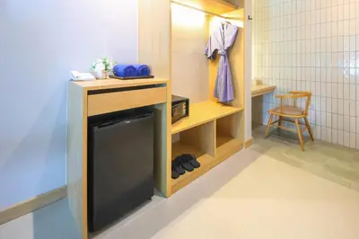 a small bathroom with a tv in a room at CRAFT Resort & Villas, Phuket Town - scheduled shuttle to Phuket Old Town in Phuket Town