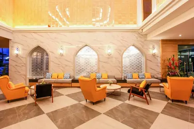 a lobby with orange chairs and couches at CRAFT Resort & Villas, Phuket Town - scheduled shuttle to Phuket Old Town in Phuket Town