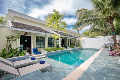a swimming pool in the backyard of a villa at CRAFT Resort & Villas, Phuket Town - scheduled shuttle to Phuket Old Town in Phuket Town