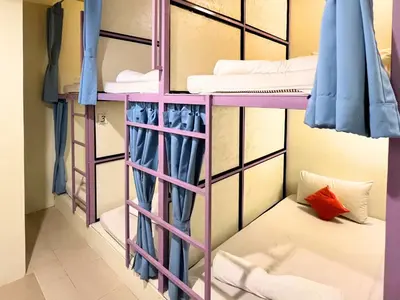 a bunk bed room with two bunk beds at Sleepy Station Hostel in Kata Beach