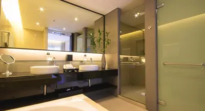 a bathroom with two sinks and a large mirror at Thanyapura Sports & Health Resort in Thalang
