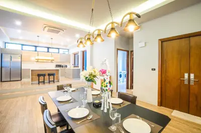 a dining room and kitchen with a table and chairs at Nakara Hill Phuket in Chalong