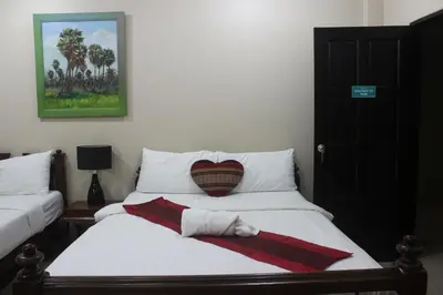 a bed with a heart pillow on top of it at Freedom Kata in Kata Beach