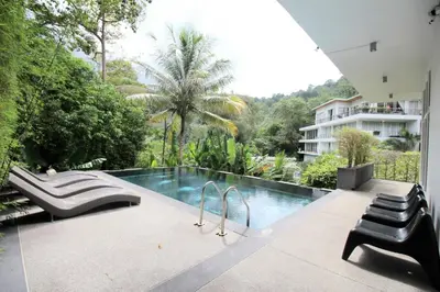 a swimming pool in the middle of a building at Zen Hillside Self Service Apartment in Kamala Beach