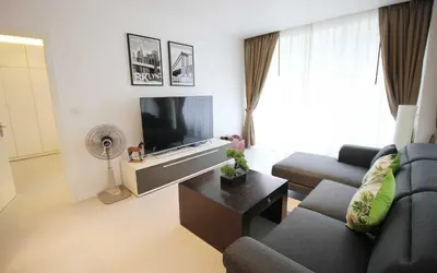 a living room with a couch and a tv at Zen Hillside Self Service Apartment in Kamala Beach