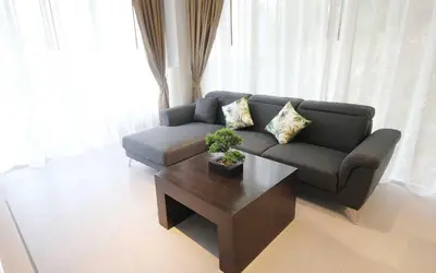 a living room with a couch and a coffee table at Zen Hillside Self Service Apartment in Kamala Beach