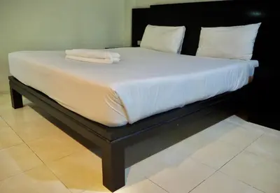 a large bed with white sheets and towels on it at Orm Thong Hotel - SHA Plus in Kathu