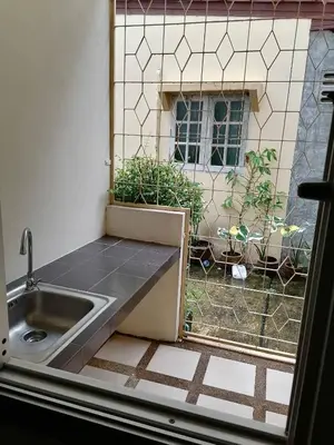 a kitchen with a sink and a window at Orm Thong Hotel - SHA Plus in Kathu