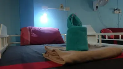 a room with a bed with a green object on it at Rehab Hostel in Phi Phi Don